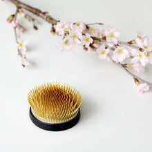 Load image into Gallery viewer, Radial kenzan posing next to a branch with cherrym blossom flowers