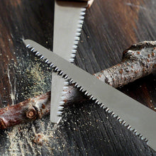 Load image into Gallery viewer, Two folding saw blades laying on a branch
