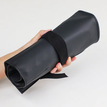 Load image into Gallery viewer, One hand holding up the roll case
