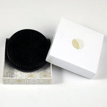 Load image into Gallery viewer, Black round kenzan in its original box
