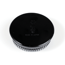 Load image into Gallery viewer, Close up on the roun d black kenzan logo on the back
