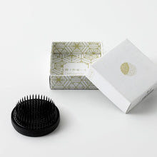 Load image into Gallery viewer, 61mm Round blakc kenzan next to its original white packaging
